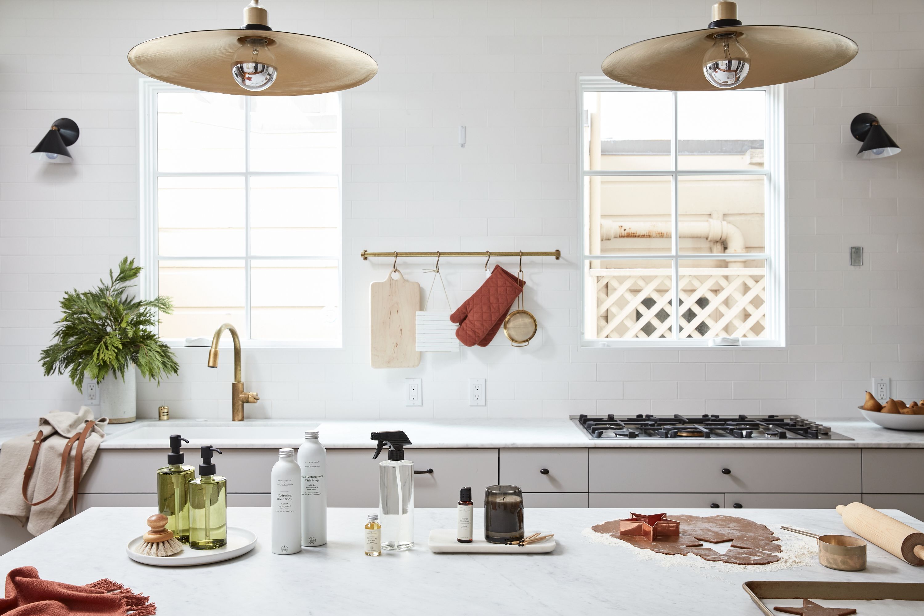 a clean, bright white kitchen with Grove cleaning supplies