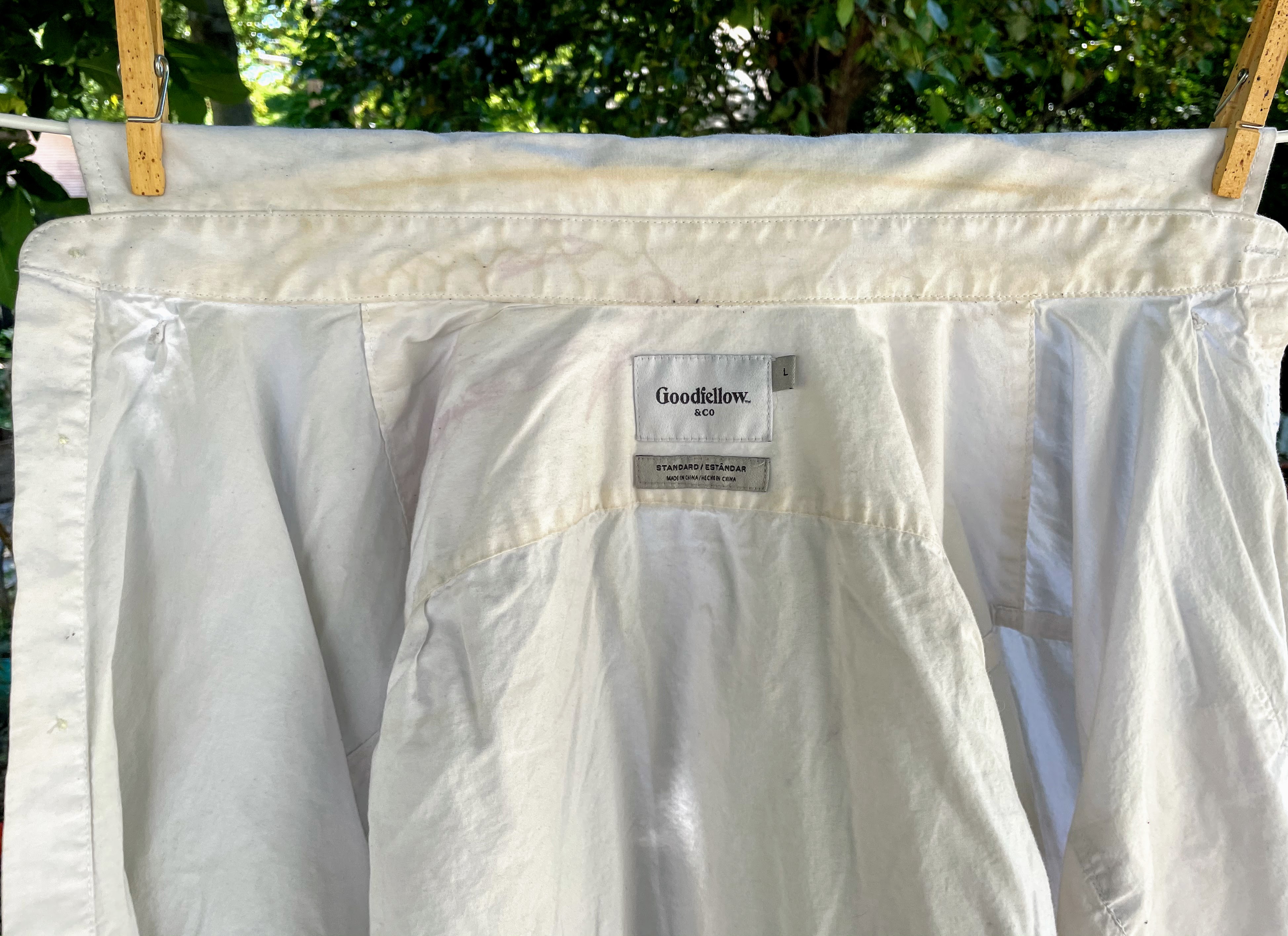 Photo of dirty white shirt hanging on clothesline