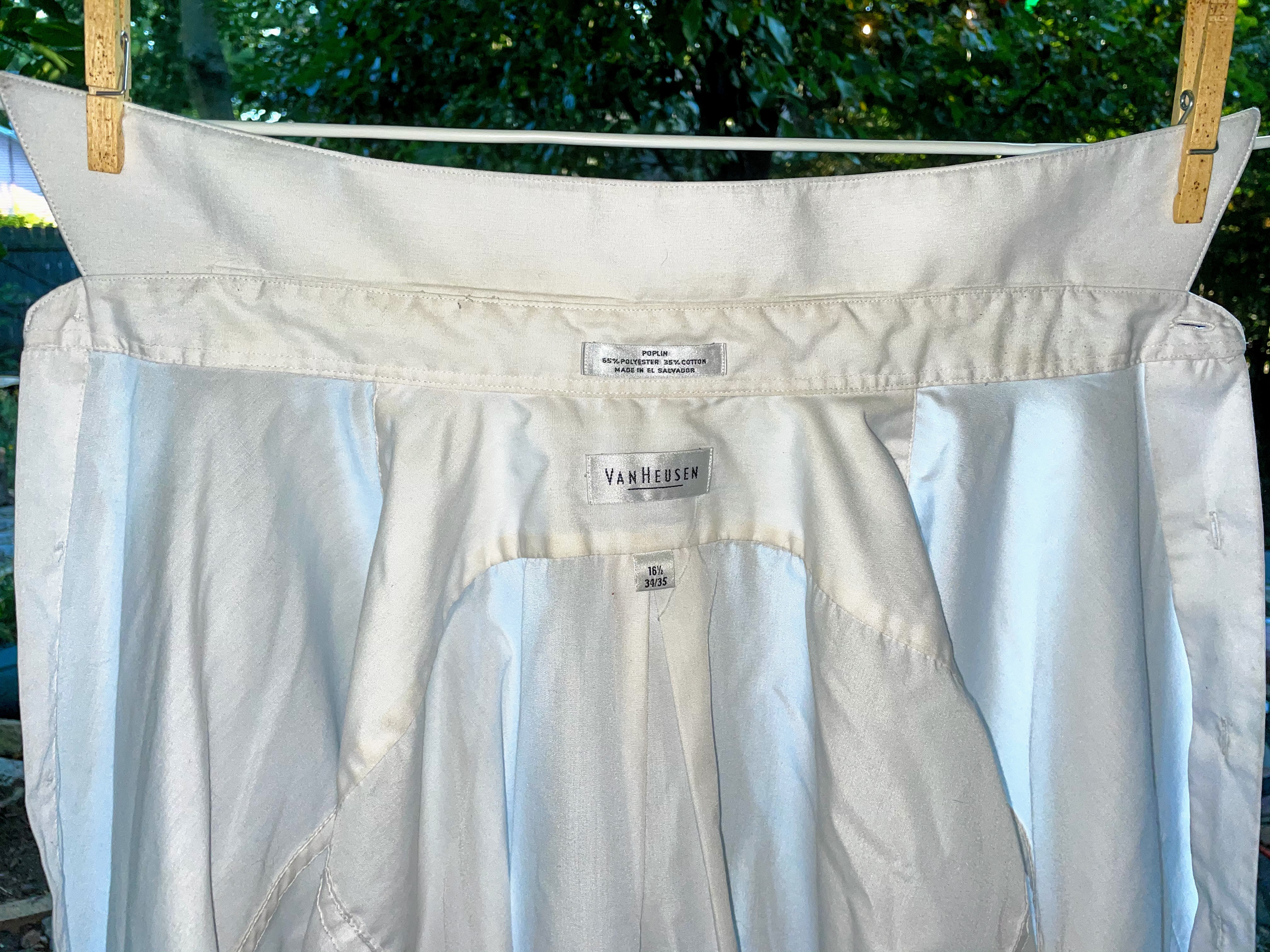 Photo of clean white shirt hanging on clothesline