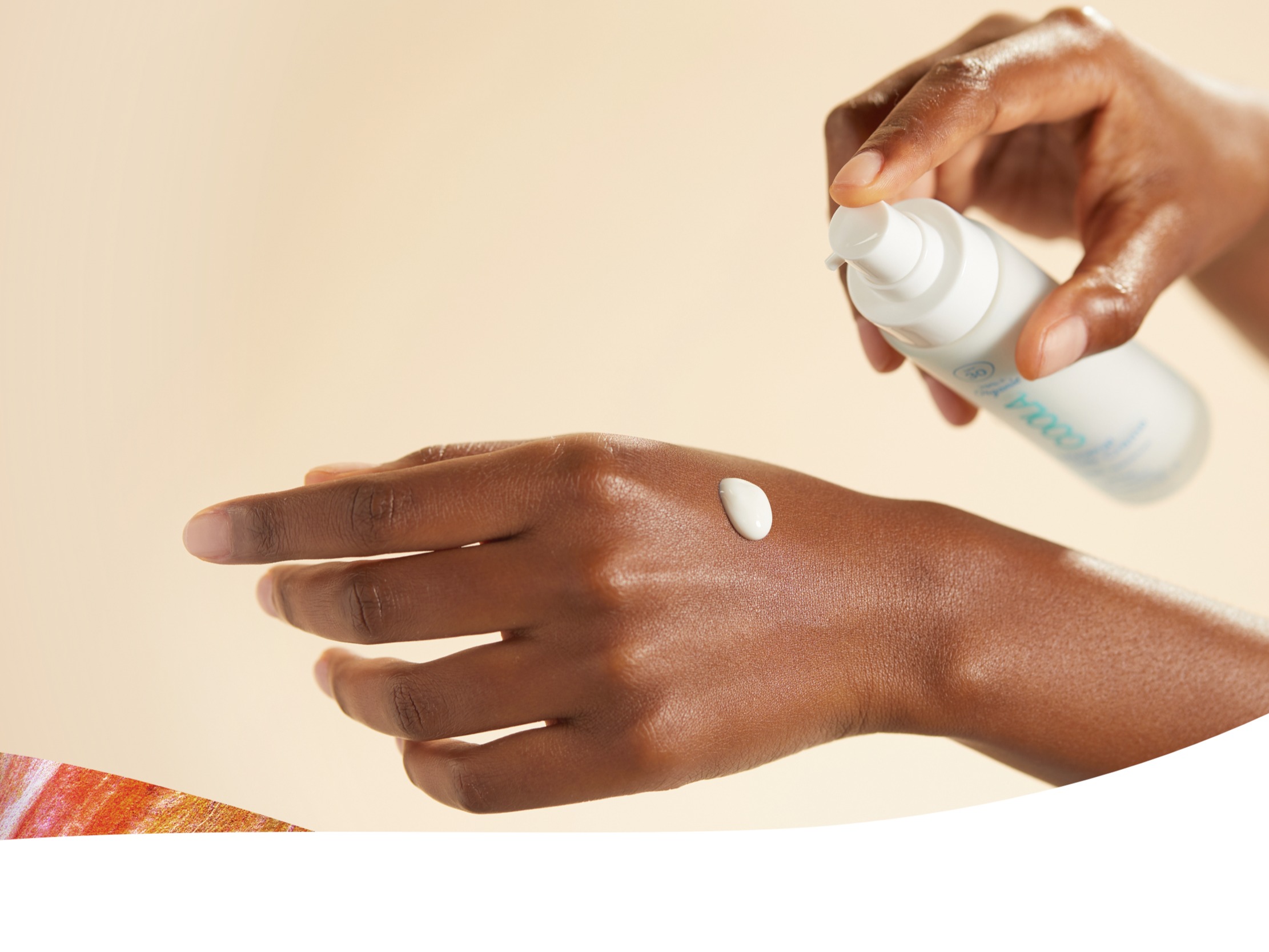 Image of someone holding lotion bottle dripping a bit on skin of other hand