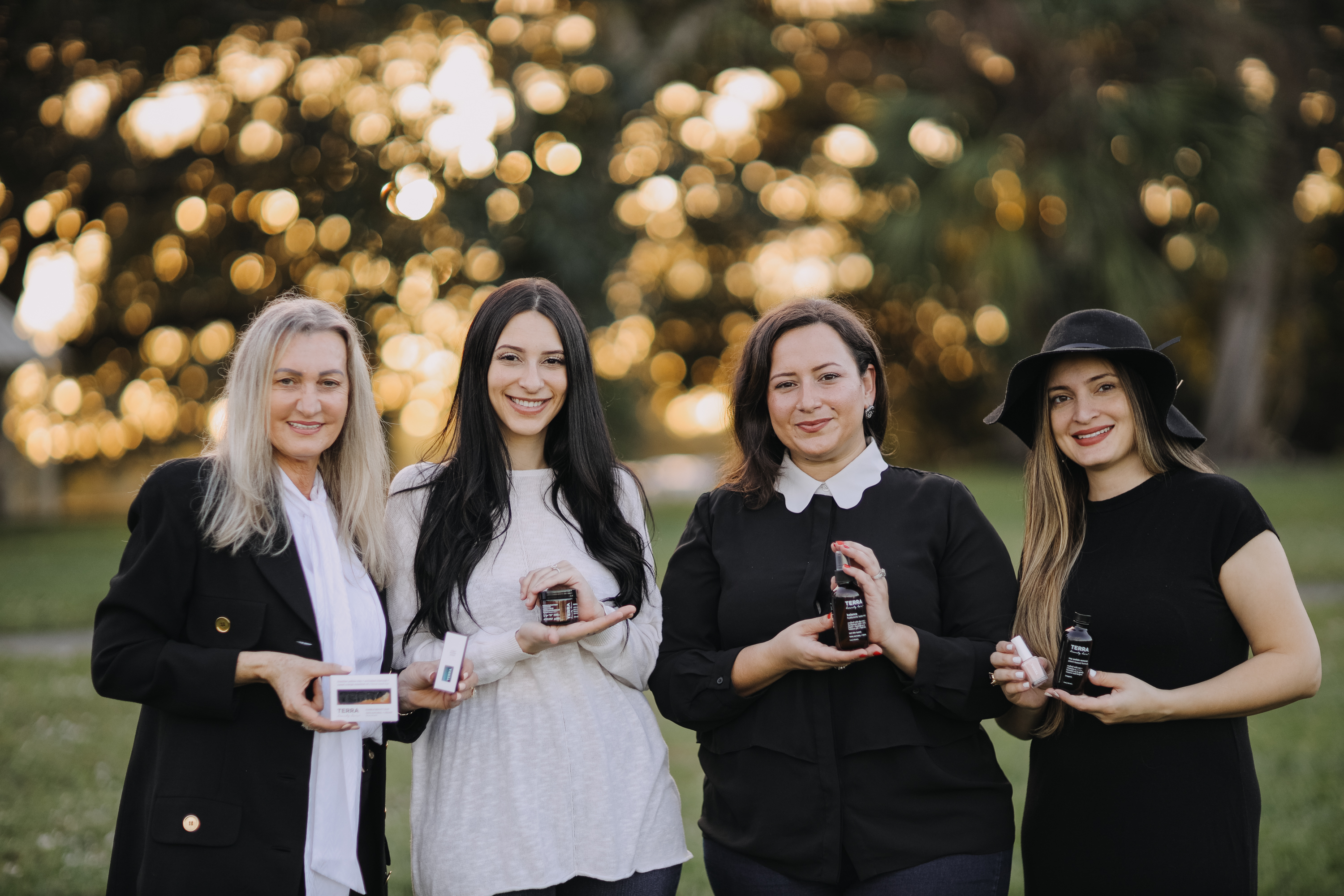 Photo of four Terra Beauty co-founders holding Terra Beauty products