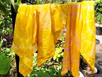 yellow tie-dyed scarves hanging outside