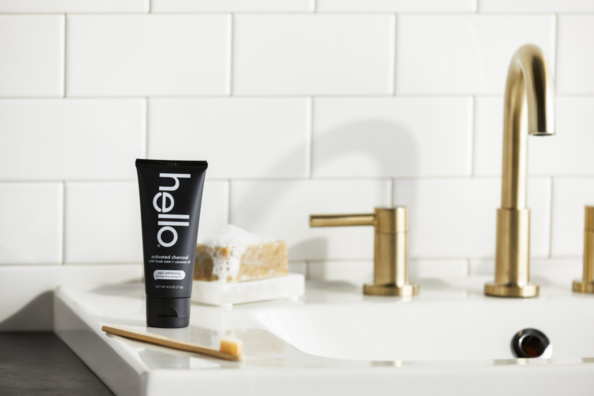Photo of hello activated charcoal toothpaste on sink with toothbrush