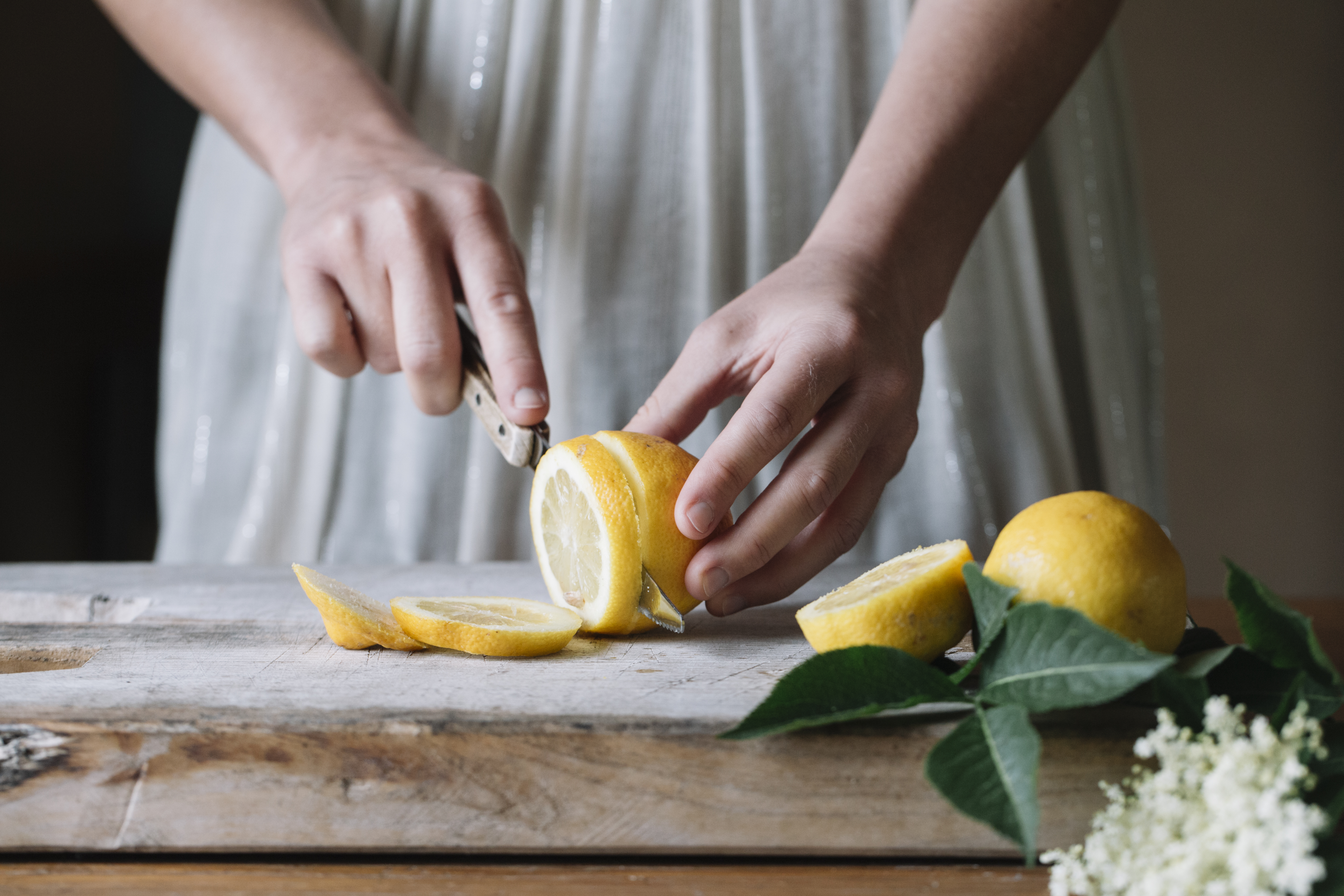 Woman cutting fresh lemons for her natural cleaning products