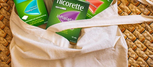 Bag containing Nicorette Microtabs, Nicorette Inhalator and Nicorette Invisipatch products