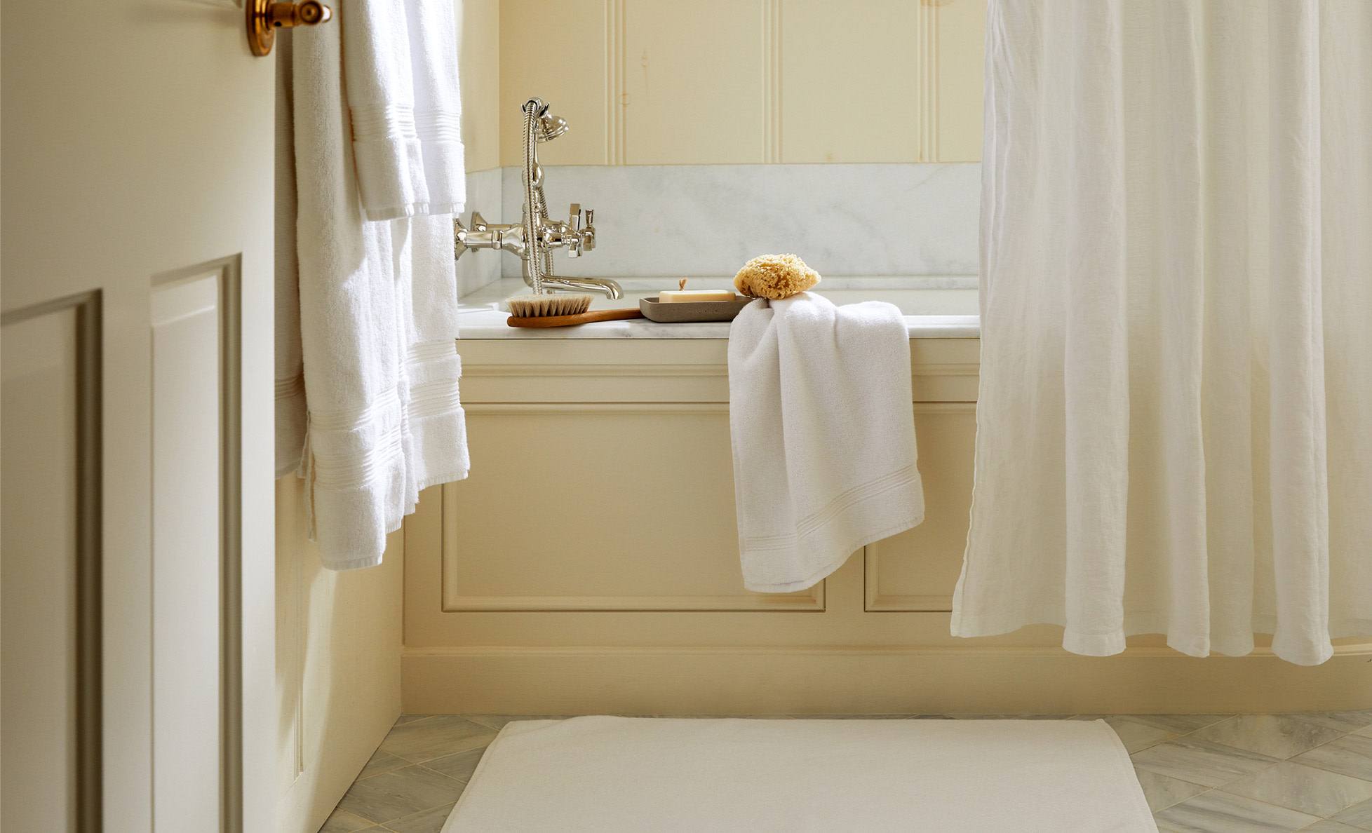 A bright bathroom with white towels