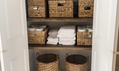 linen closet with baskets 