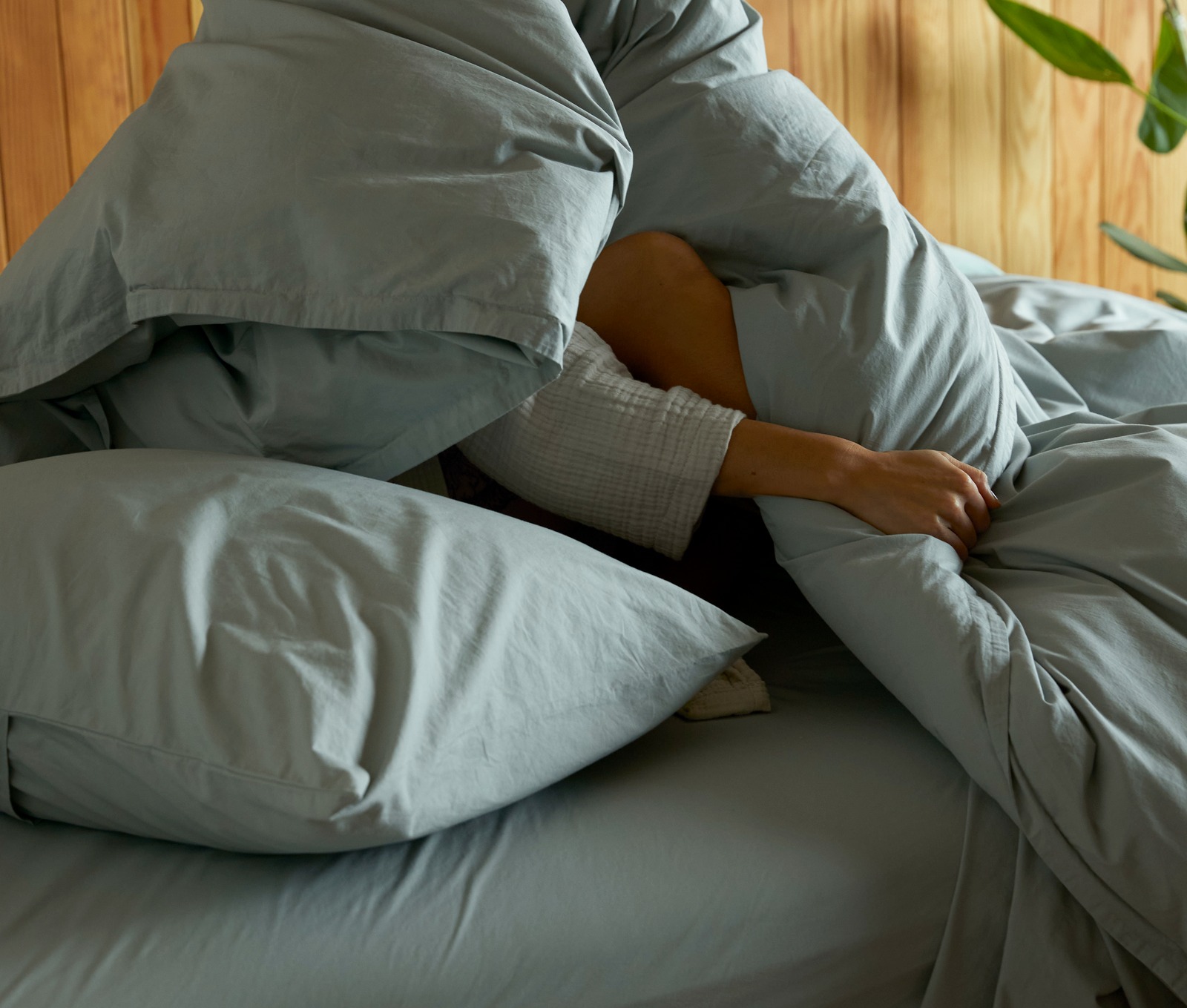 A messy bed with bone sateen sheets