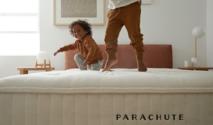 Two kids jumping on mattress