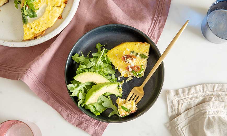 Finished frittata with a side of arugula and avocado. 