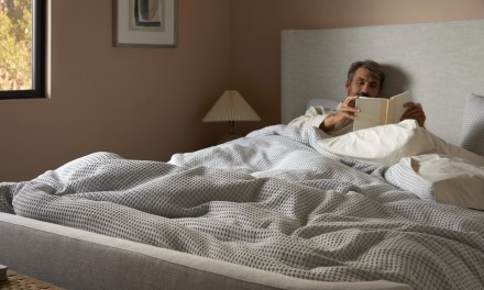 man in bed reading