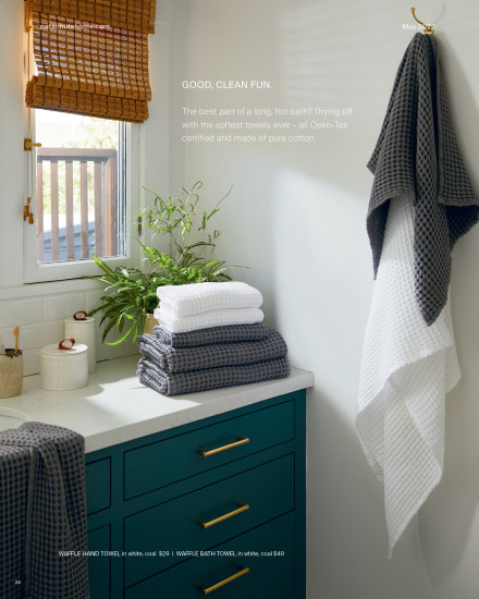 A bathroom with a set of towels in coal and white.