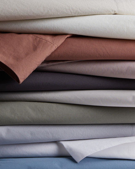 A stack of percale sheets in various colors