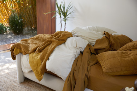 Messy bed with Ochre sheeting