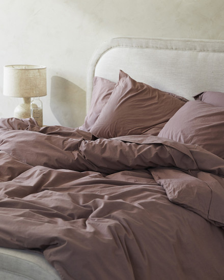 A messy bed with clover mauve brushed cotton sheets