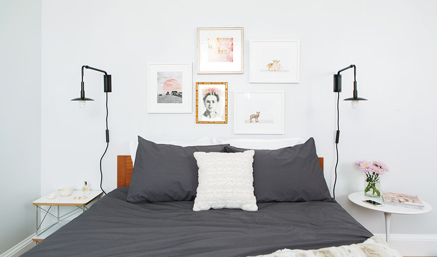 Several photographs framed over a bed