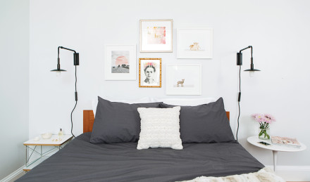 Several photographs framed over a bed