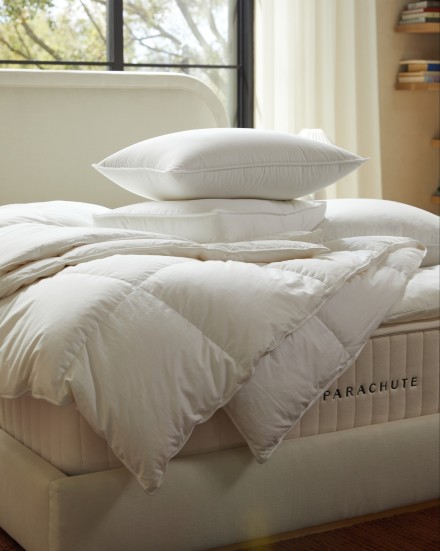 A bare mattress with pillow and duvet inserts