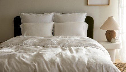 heirloom tencel linen sheets in white on a bed 