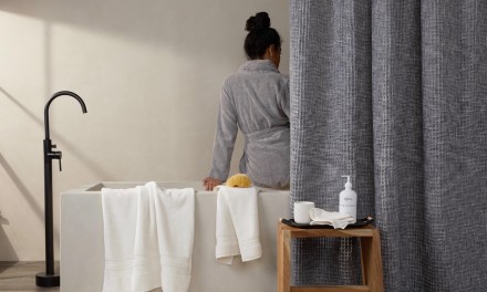 woman sitting on ledge of bath tub. 