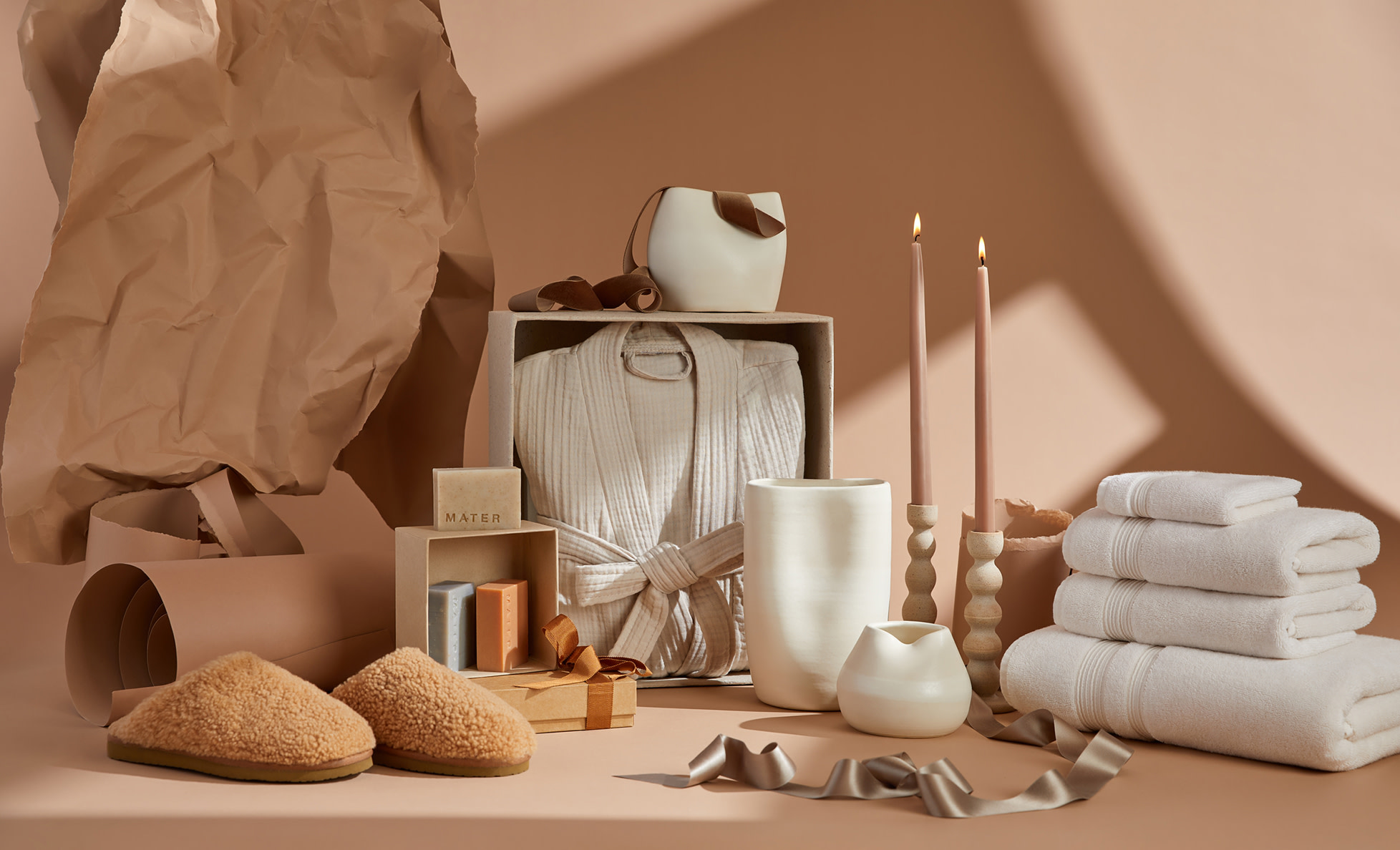 Holiday selection of gift items on a tan backdrop