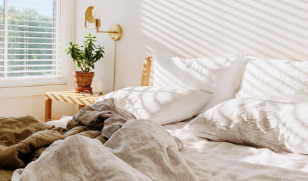 Ruffled bedding with morning light shone through blinds