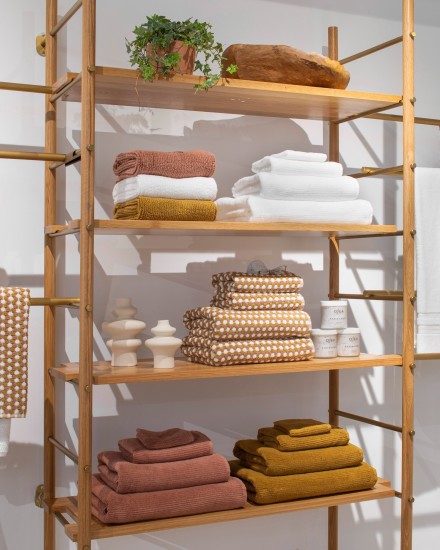 Shelves stacked with various soft towels