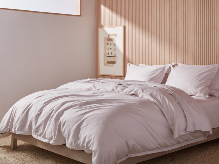 Side view of a clean bed with Blush sheeting