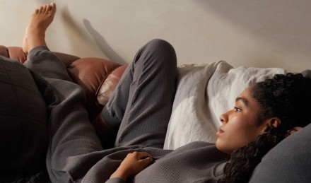 Woman in Slate loungewear on couch. 