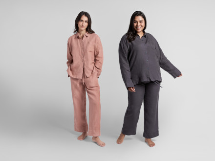 Two women modeling the women's linen top on a white backdrop