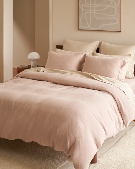 A bed with haze linen and bone percale sheets