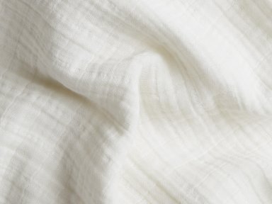 Close Up Of Cream Muslin Swaddle Blanket