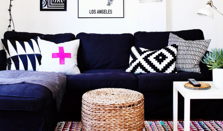 Navy couch with a pink pillow