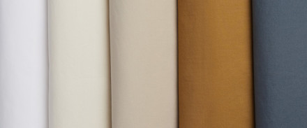 A row of brushed cotton sheets in various colors