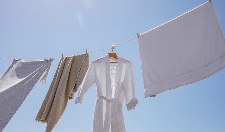 Robes, linens, and towels on a clothesline. 