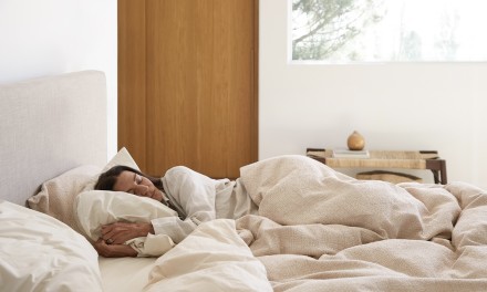 a shot of a person sleeping comfortably in bed