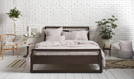 Image of a bedroom with potted plants. 