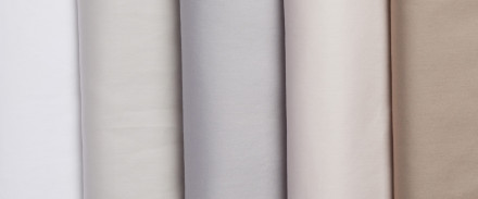A row of sateen sheets in various colors