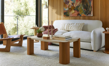 A bright living room with a plush sofa and modern coffee table