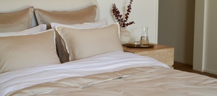 A neat bed with white and bone soft luxe sheets