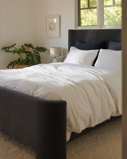 A bed with crisp white organic cotton sheets
