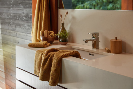 Ochre stack of soft rib towels hanging over a sink