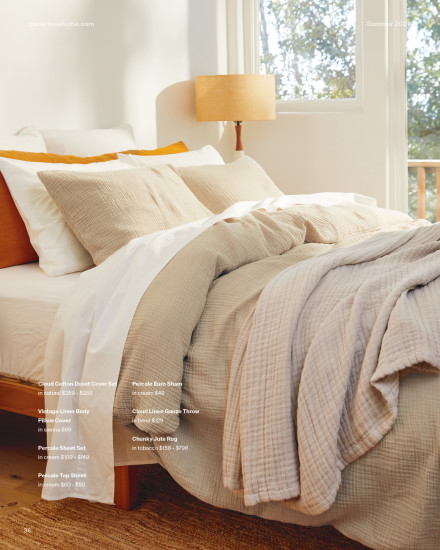 Warm themed bed made with terra colored pillows and a tan throw