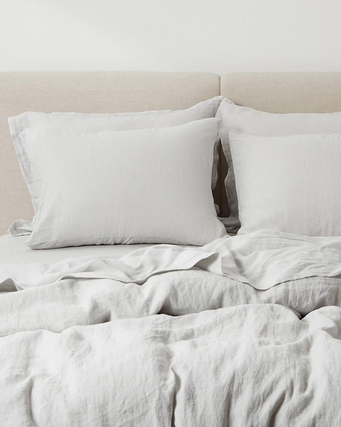 A bed with fog linen sheets