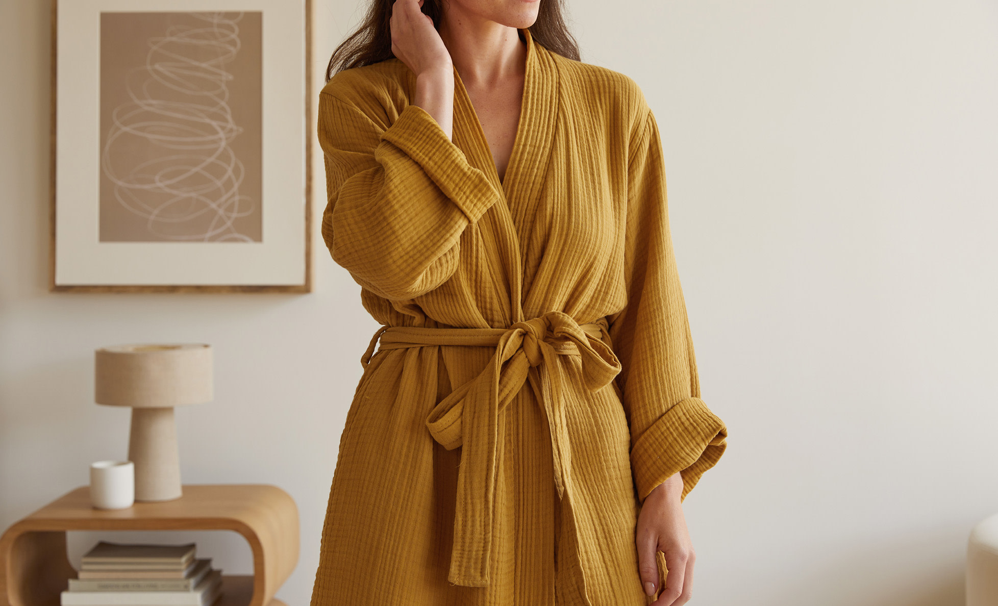 A woman wearing a cozy amber yellow robe