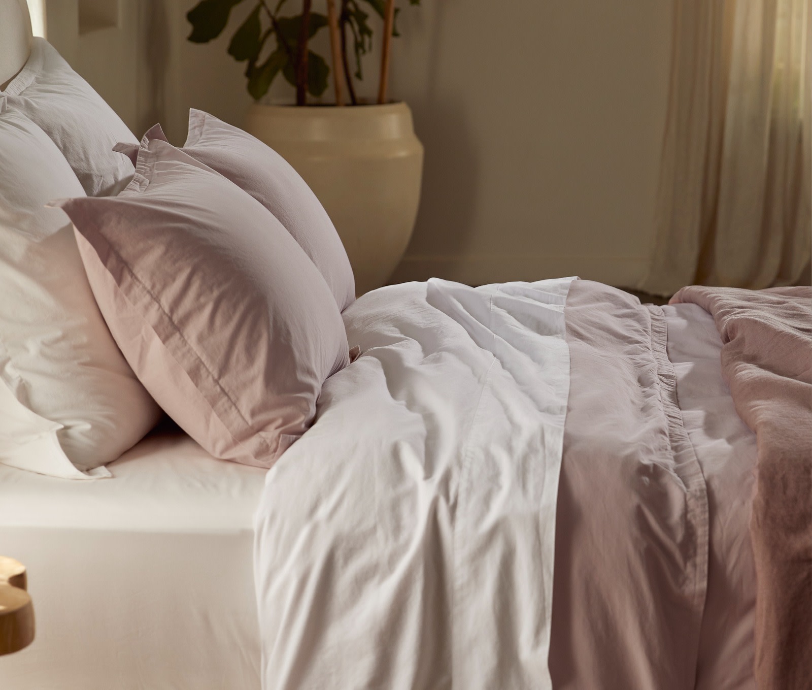 A bed with crisp white percale sheets