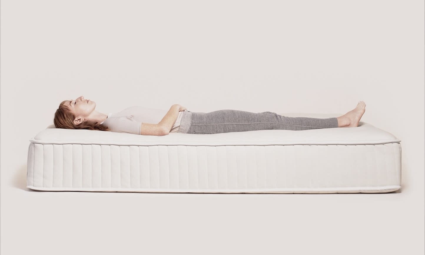 woman on a mattress sleeping on her side 