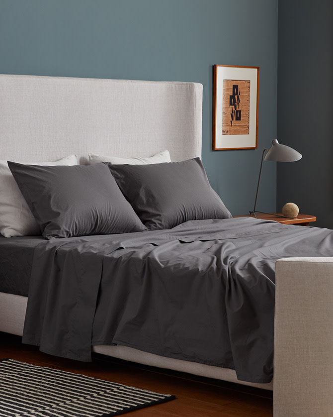 A neat bed with dark grey slate percale sheets
