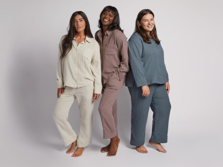 Three women wearing gauze sleepwear in ivory, purple, and blue