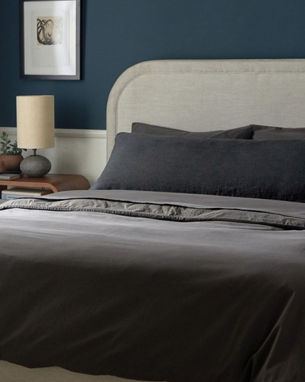 A neat bed with dark grey shale organic cotton sheets